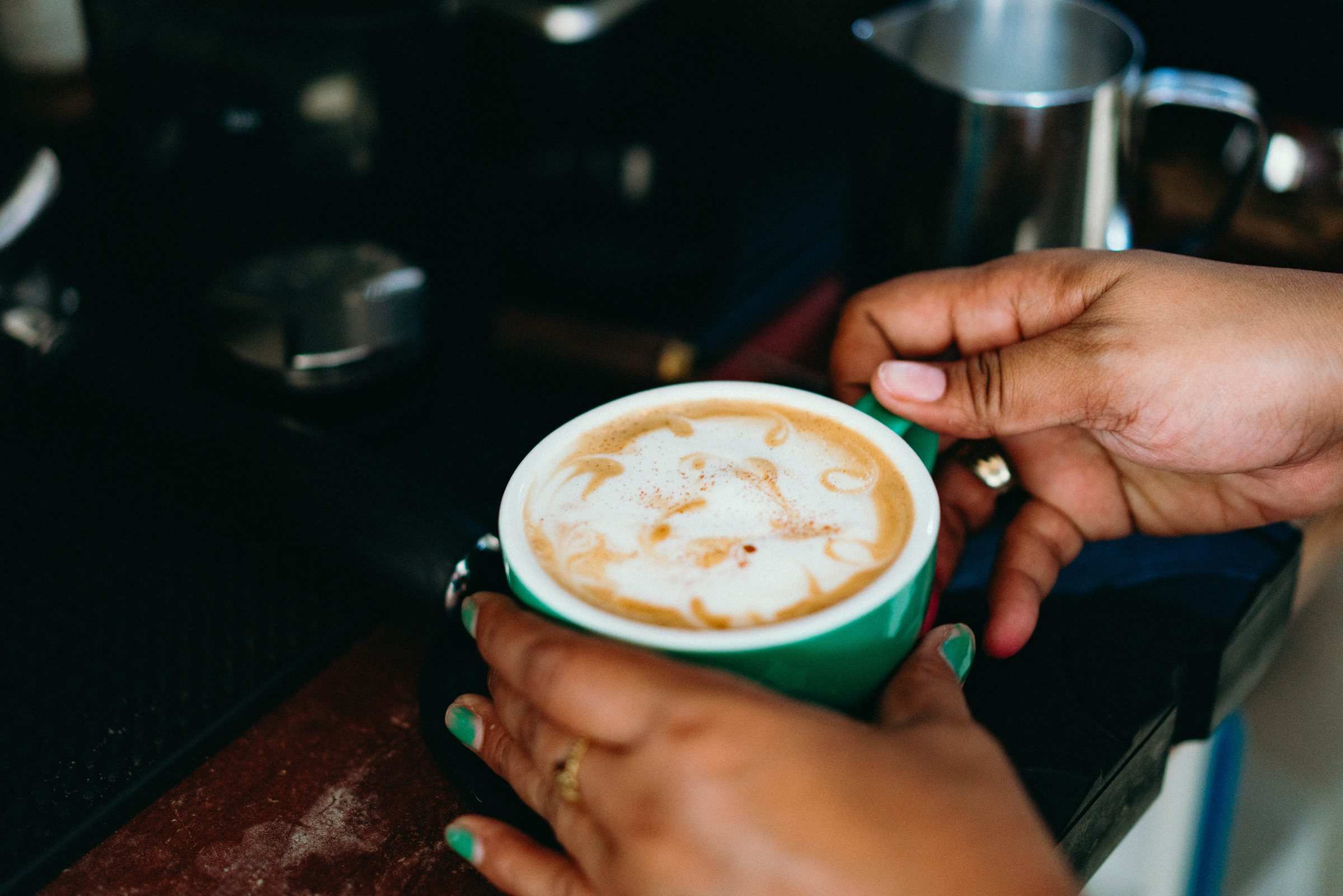 Latte art in a green cup