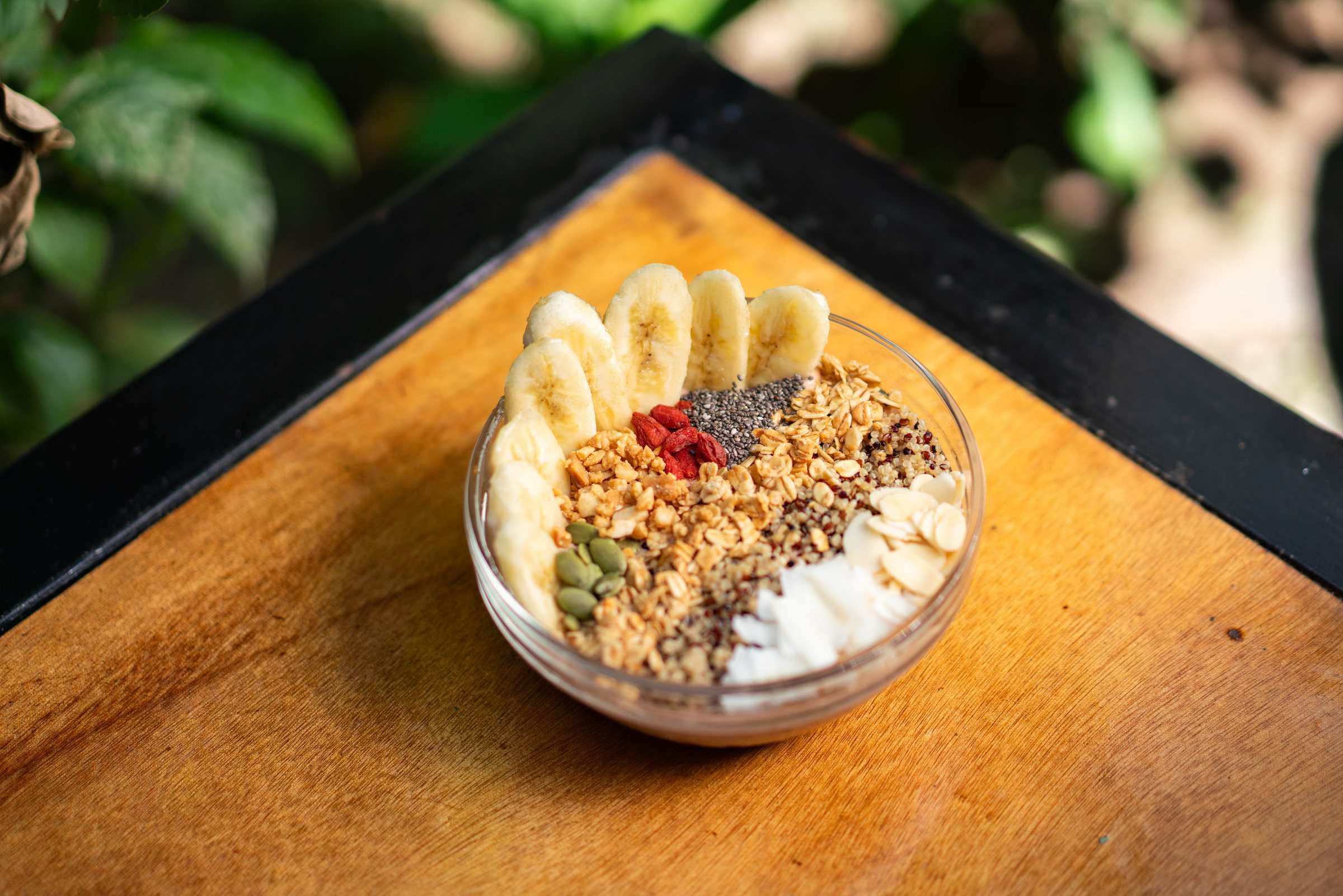 Breakfast smoothie bowl with granola and banana