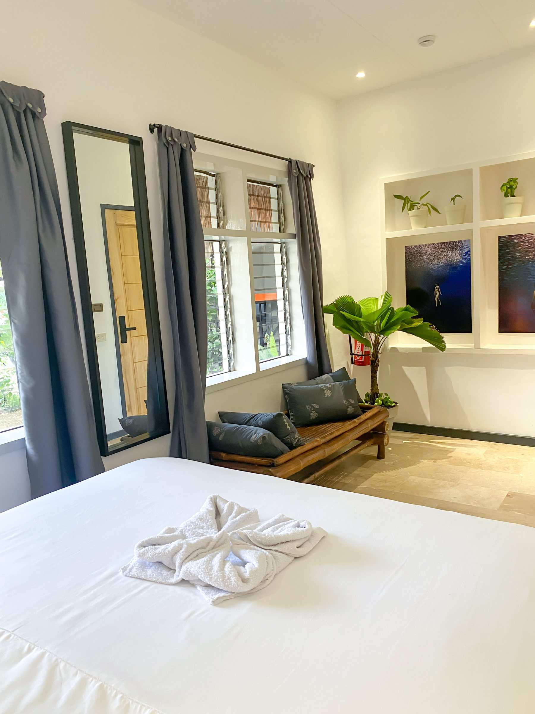 Bed and window seat in the Private Deluxe room