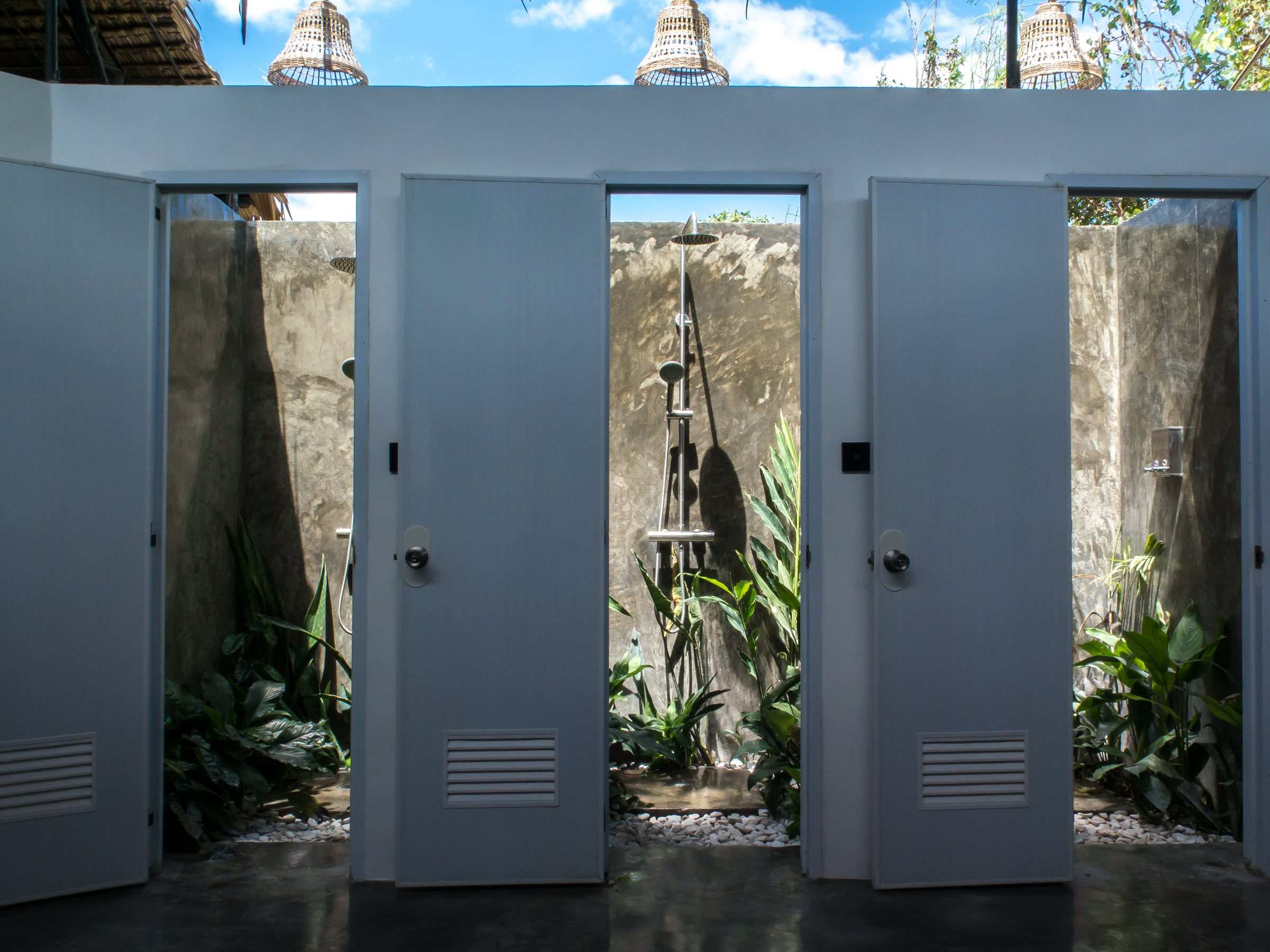 Row of open-air shower cubicles